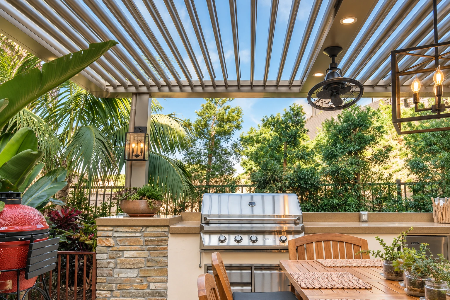 Patio cover with adjustable slatted roof shading an outdoor kitchen and dining area.