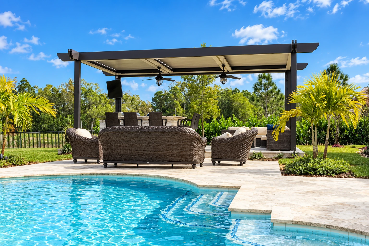 Patio cover installation with a dark-framed roof shading wicker seating beside a swimming pool.